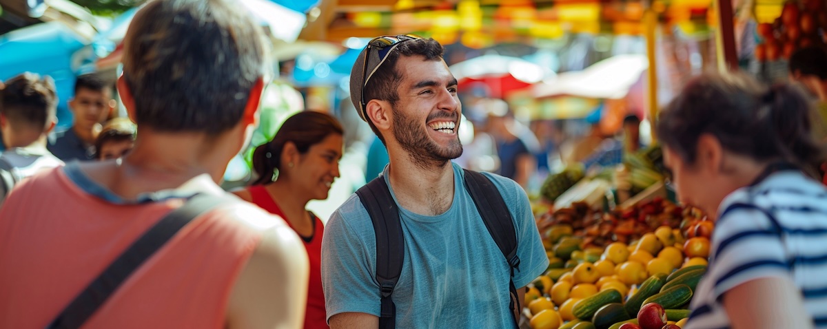 English-speaking traveler having a real Spanish conversation at a Latin American market