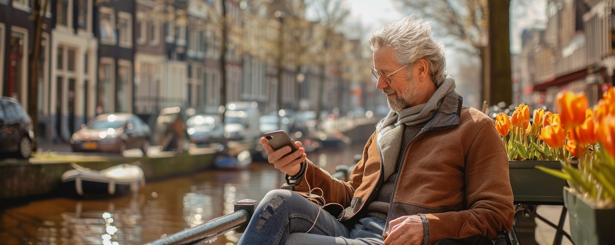 Common Dutch phrases for everyday life — a language learner practising Dutch beside an Amsterdam canal