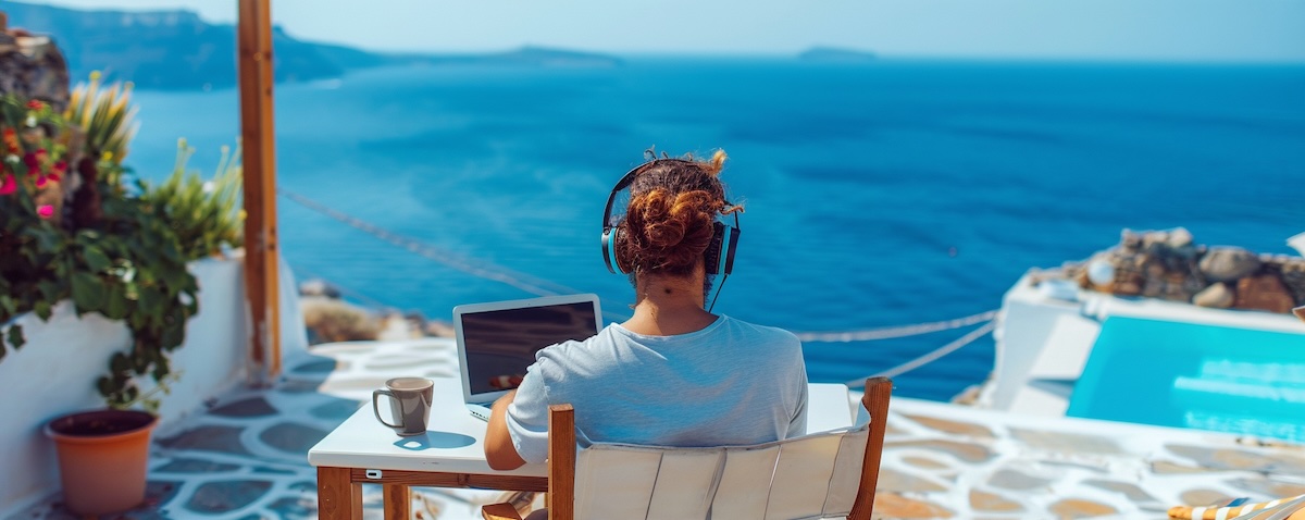 Adult learner studying Greek with an online course on a terrace in Greece