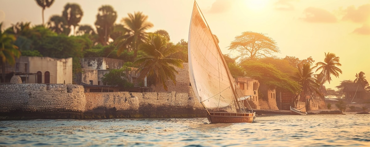 Swahili språk: tradisjonelle dhow-seilbåter foran en gammel by på swahilikysten